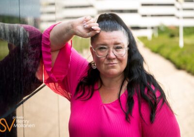 Nainen nojaa seinään.